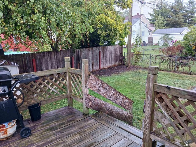 wooden deck featuring a yard