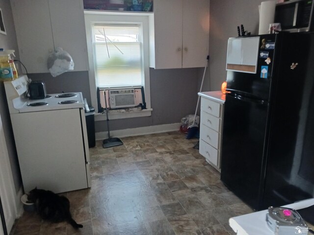 kitchen featuring white stove, white cabinetry, black fridge, and cooling unit