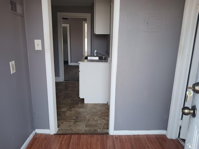 639 Michigan Ave, Monroe, MI 48162 - hall featuring wood finished floors, baseboards, visible vents, and a sink