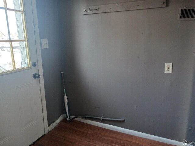 639 Michigan Ave, Monroe, MI 48162 - doorway to outside with dark wood finished floors, visible vents, and baseboards