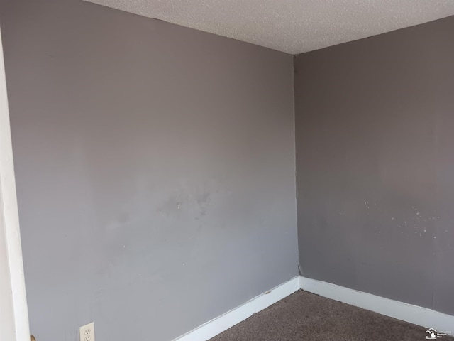 639 Michigan Ave, Monroe, MI 48162 - unfurnished room featuring dark carpet, a textured ceiling, and baseboards