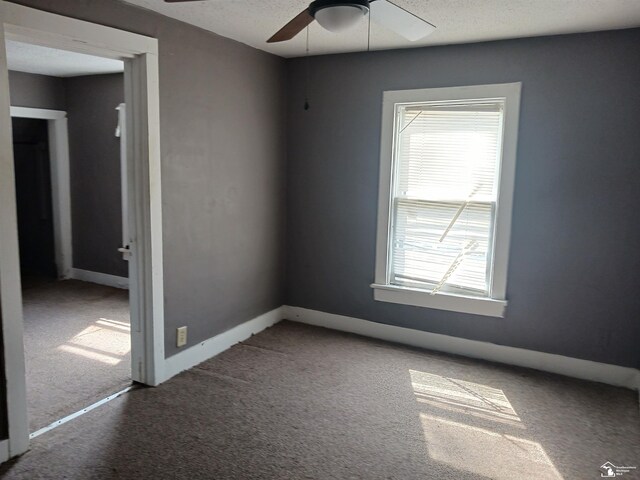 639 Michigan Ave, Monroe, MI 48162 - unfurnished room featuring a textured ceiling, carpet flooring, baseboards, and ceiling fan