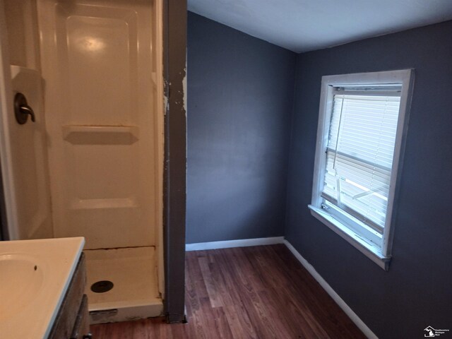 639 Michigan Ave, Monroe, MI 48162 - full bath with a shower stall, vanity, baseboards, and wood finished floors