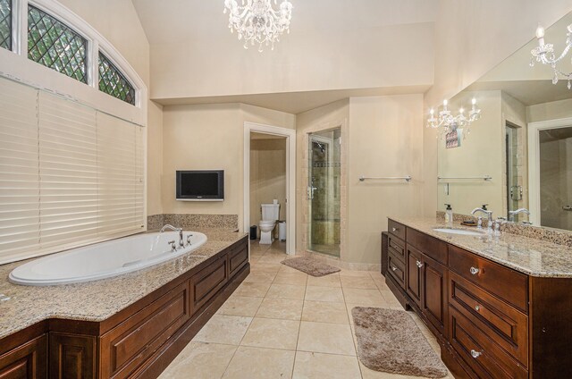 26061 Hawthorne Dr, Franklin, MI 48025 - full bath with a chandelier, vanity, toilet, a garden tub, and a stall shower