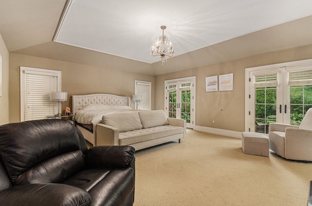 bedroom featuring access to exterior, light carpet, multiple windows, and an inviting chandelier