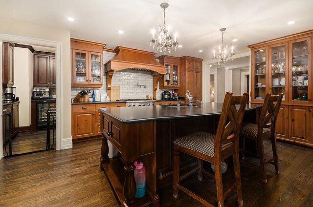 26061 Hawthorne Dr, Franklin, MI 48025 - kitchen with dark countertops, a chandelier, custom range hood, dark wood-type flooring, and tasteful backsplash