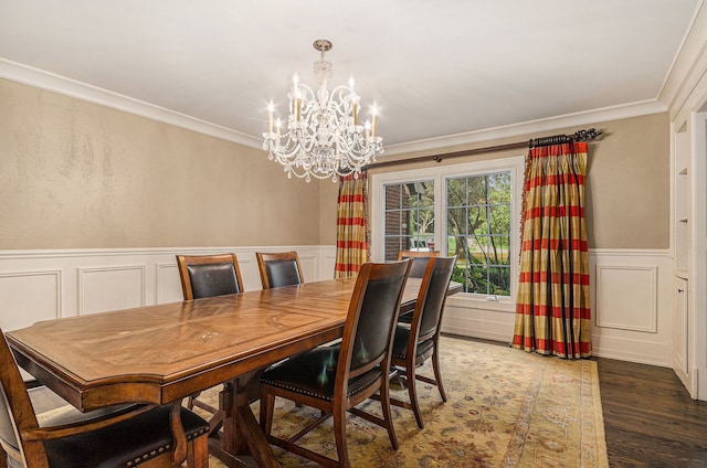 dining area with a chandelier, crown molding, and dark wood-type flooring