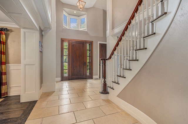 26061 Hawthorne Dr, Franklin, MI 48025 - entryway with baseboards, stairs, a high ceiling, and stone tile flooring