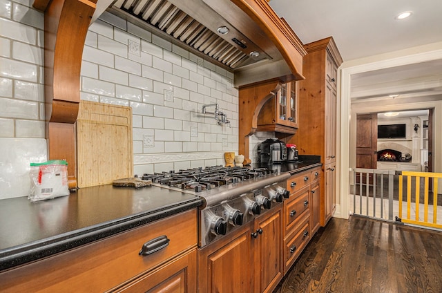 kitchen featuring stainless steel gas stovetop, dark hardwood / wood-style flooring, backsplash, and custom exhaust hood