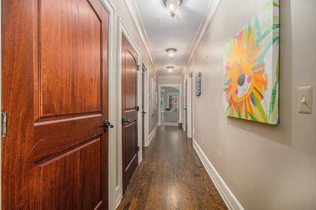 hall with dark hardwood / wood-style flooring and ornamental molding