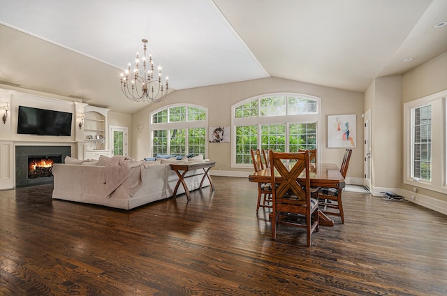 26061 Hawthorne Dr, Franklin, MI 48025 - dining room with vaulted ceiling, dark wood-style flooring, a chandelier, a warm lit fireplace, and baseboards