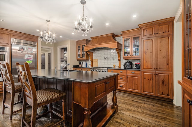 kitchen featuring sink, dark hardwood / wood-style floors, a notable chandelier, custom range hood, and stainless steel appliances