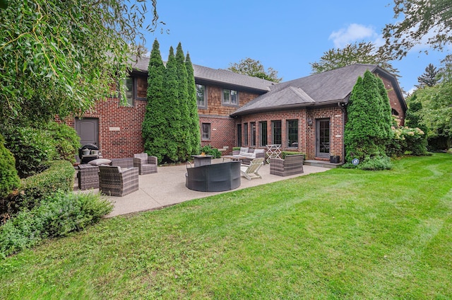 rear view of property featuring a lawn, an outdoor living space, and a patio area