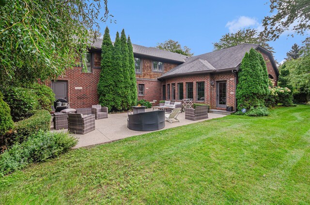 26061 Hawthorne Dr, Franklin, MI 48025 - rear view of house featuring an outdoor hangout area, a yard, a patio area, brick siding, and roof with shingles