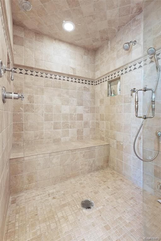 bathroom with a tile shower