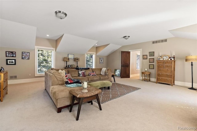 living room featuring light colored carpet and vaulted ceiling