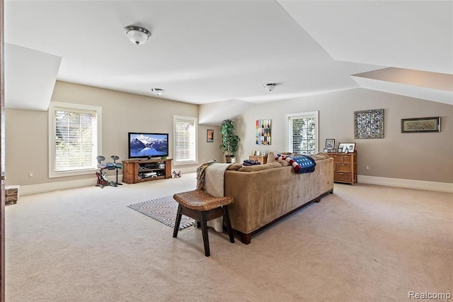 carpeted living room featuring lofted ceiling