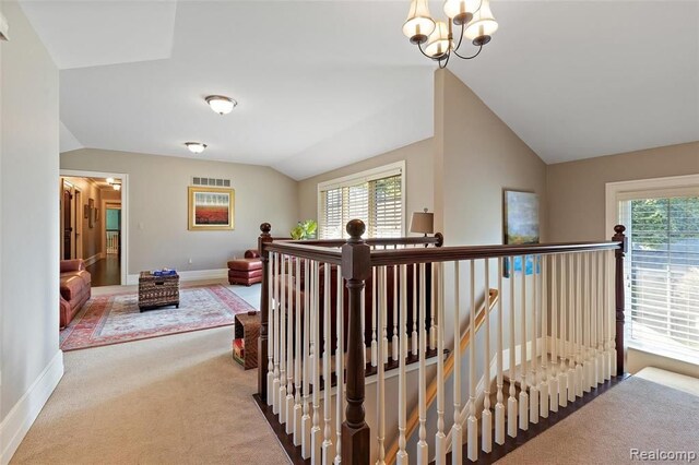 26061 Hawthorne Dr, Franklin, MI 48025 - corridor featuring an upstairs landing, lofted ceiling, carpet, baseboards, and a chandelier