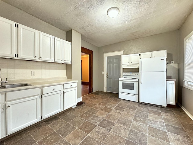 kitchen featuring white appliances, backsplash, white cabinetry, and sink