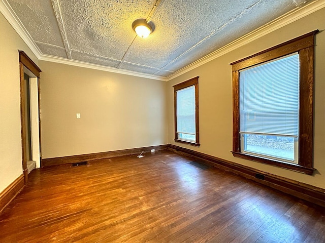 unfurnished room featuring hardwood / wood-style floors, a textured ceiling, and ornamental molding