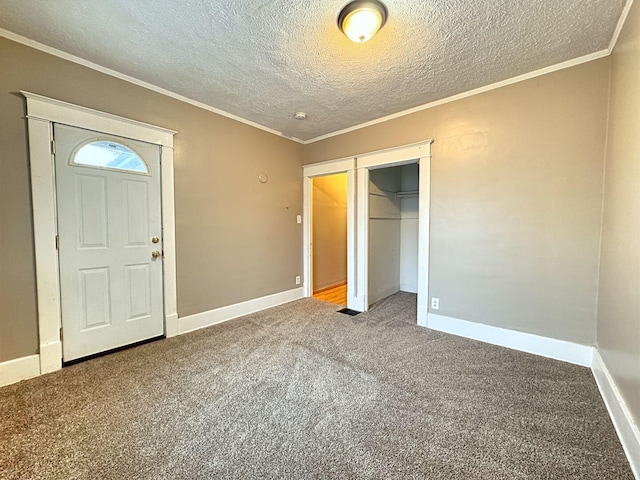 interior space with crown molding, a closet, carpet floors, and a textured ceiling