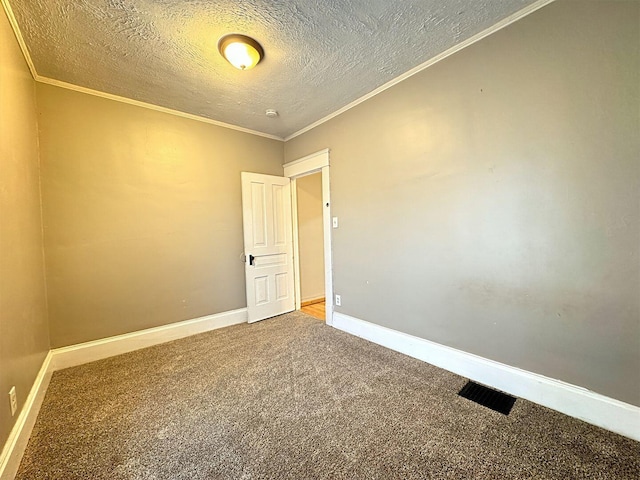 unfurnished room with crown molding, carpet floors, and a textured ceiling