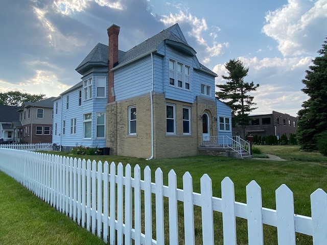 victorian-style house featuring a front yard