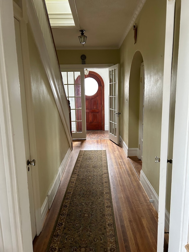 entryway featuring hardwood / wood-style floors and ornamental molding