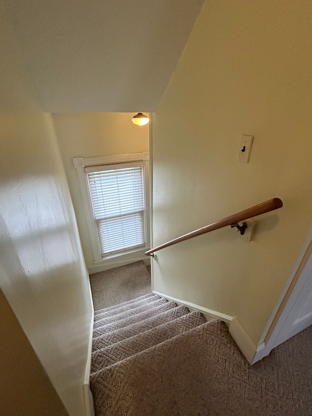 stairs featuring carpet flooring and lofted ceiling