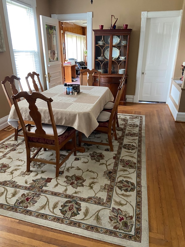 dining space with plenty of natural light and wood-type flooring