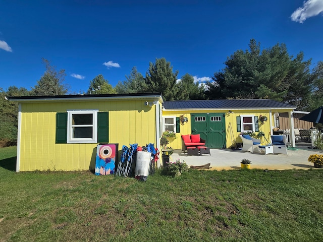 back of property featuring a lawn and a patio area