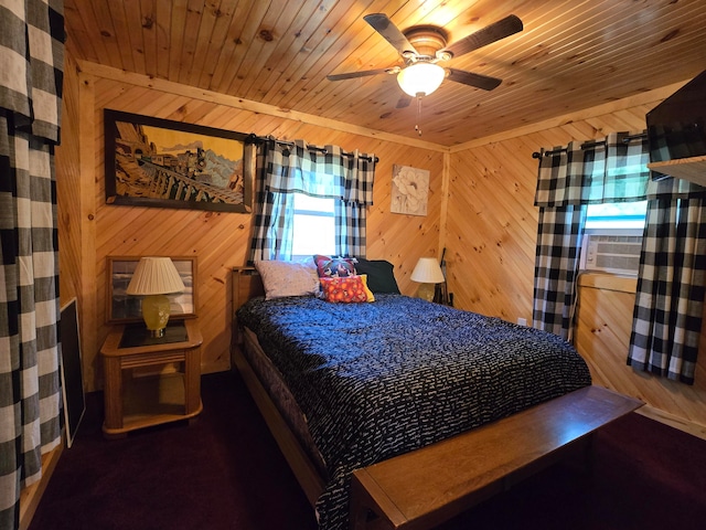 bedroom with ceiling fan, multiple windows, and wood walls