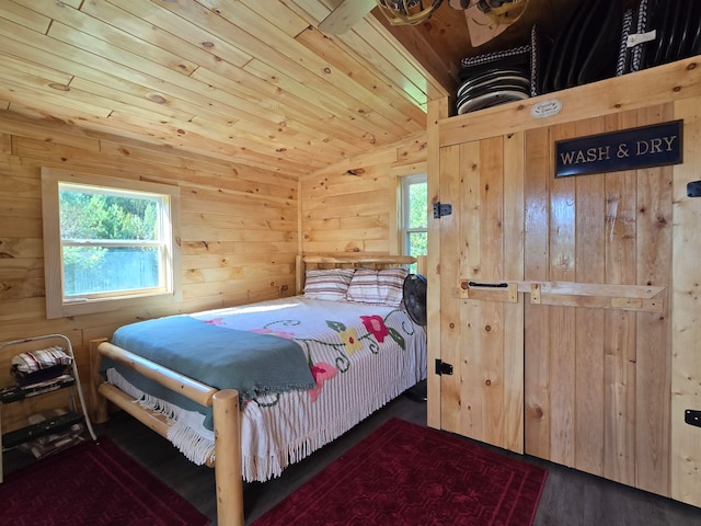 bedroom featuring multiple windows, wood walls, dark hardwood / wood-style floors, and lofted ceiling