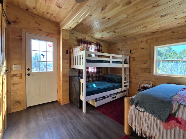 bedroom featuring dark hardwood / wood-style floors, wooden ceiling, wooden walls, and vaulted ceiling