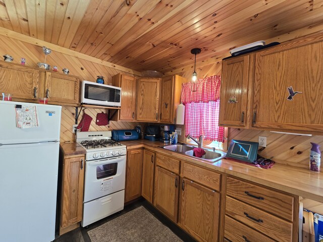 12259 Niemi, Kaleva, MI 49645 - kitchen featuring white appliances, a sink, brown cabinets, wood ceiling, and wood walls