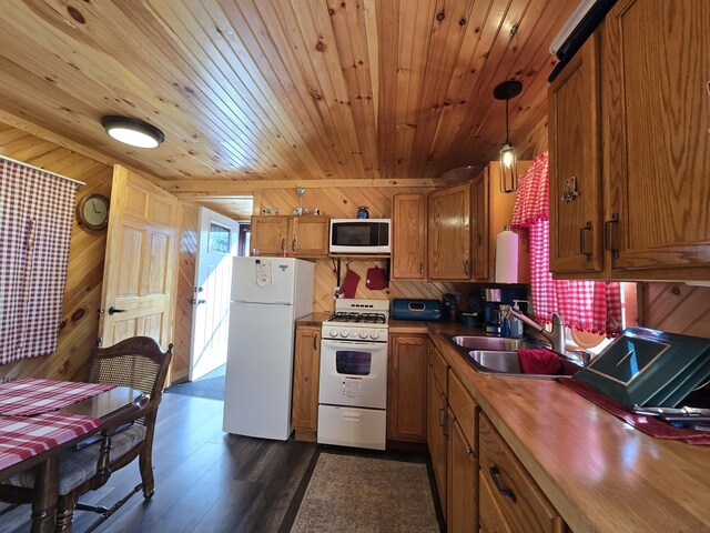 12259 Niemi, Kaleva, MI 49645 - kitchen featuring white appliances, a sink, brown cabinetry, wood ceiling, and wooden walls
