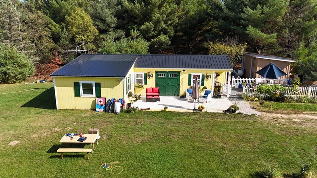 12259 Niemi, Kaleva, MI 49645 - back of house with a patio area and metal roof