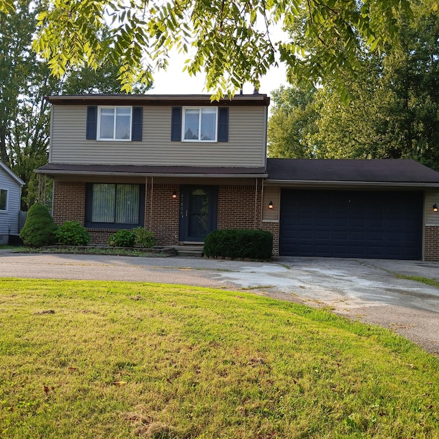 front facade featuring a garage and a front lawn