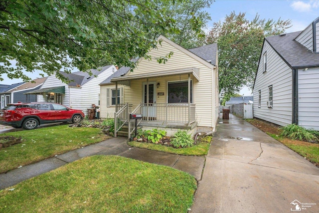 bungalow-style house with a porch and a front yard