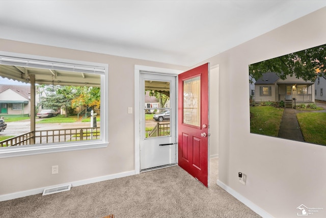 doorway to outside with carpet