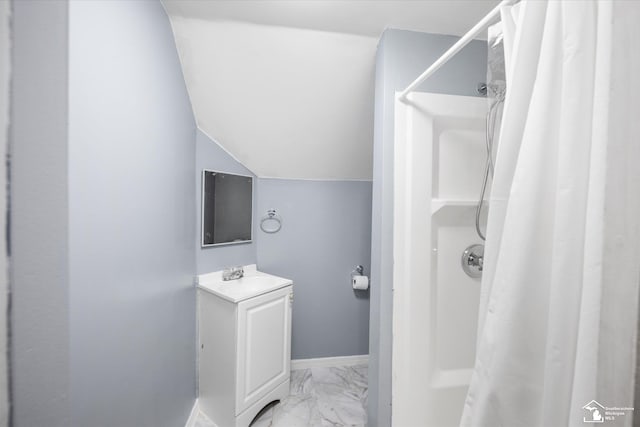 bathroom featuring a shower with shower curtain, vanity, and lofted ceiling