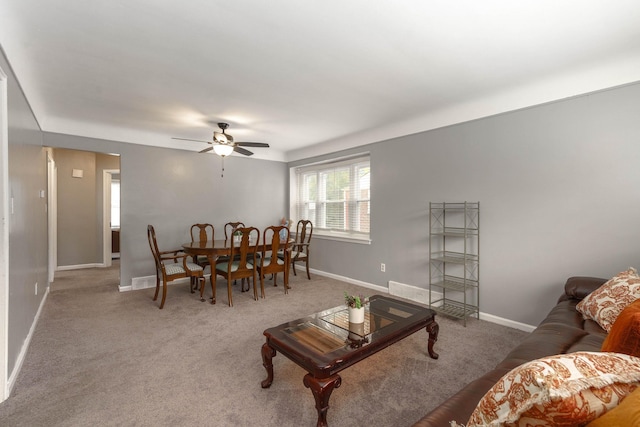 carpeted living room featuring ceiling fan