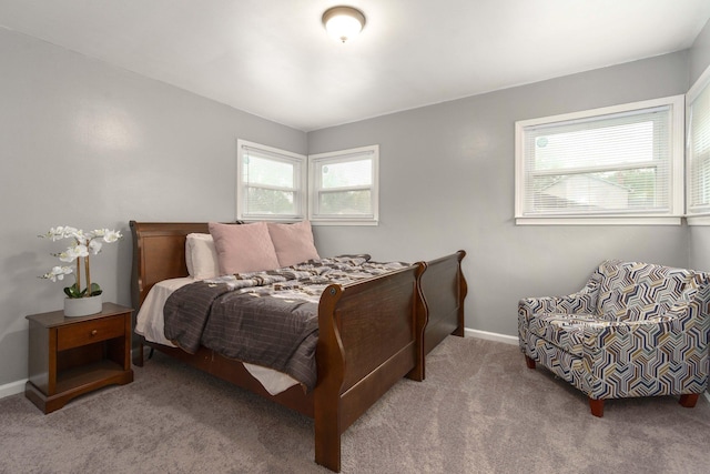 carpeted bedroom featuring multiple windows