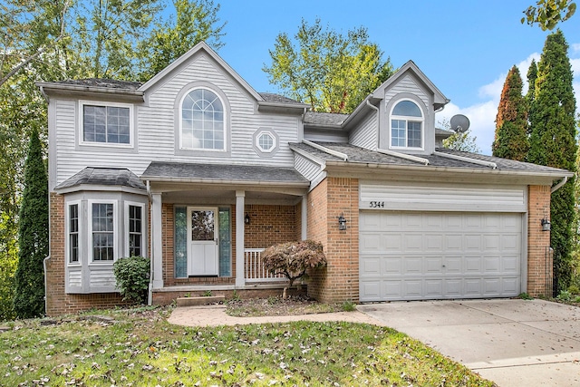 view of property with a front lawn and a garage