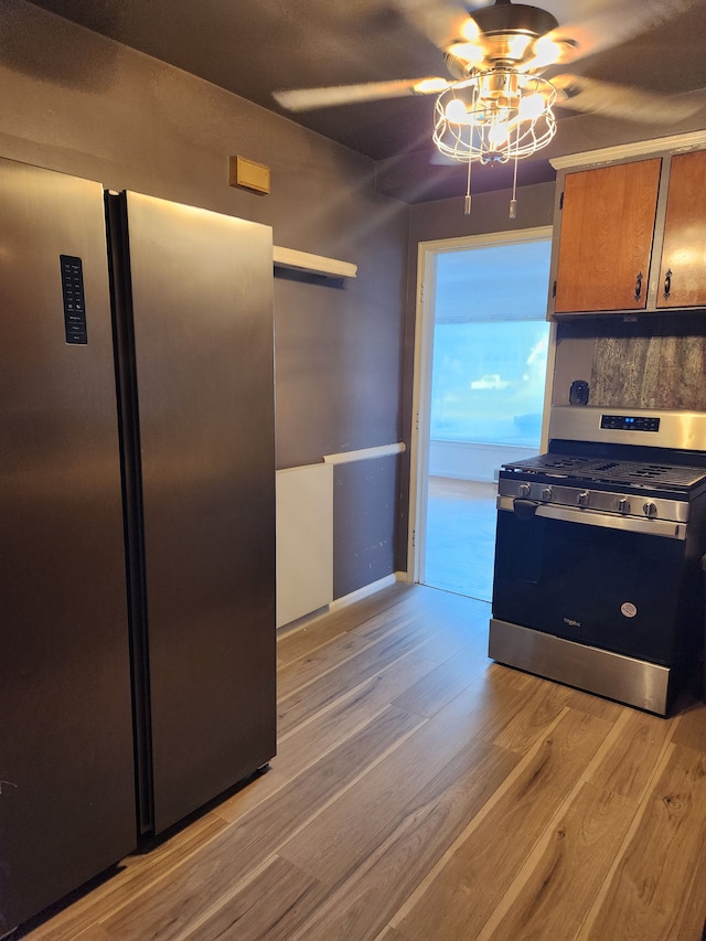 kitchen featuring light hardwood / wood-style flooring, ceiling fan, and appliances with stainless steel finishes