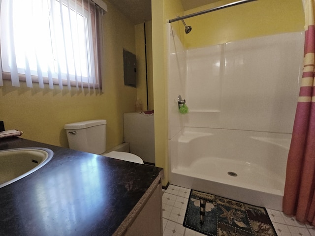 bathroom featuring a shower with curtain, electric panel, vanity, and toilet