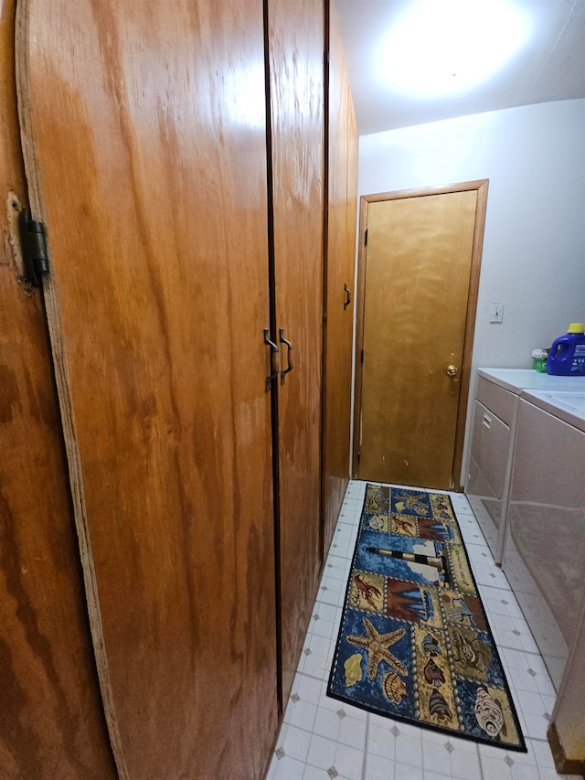 interior space featuring light tile patterned floors and washing machine and clothes dryer