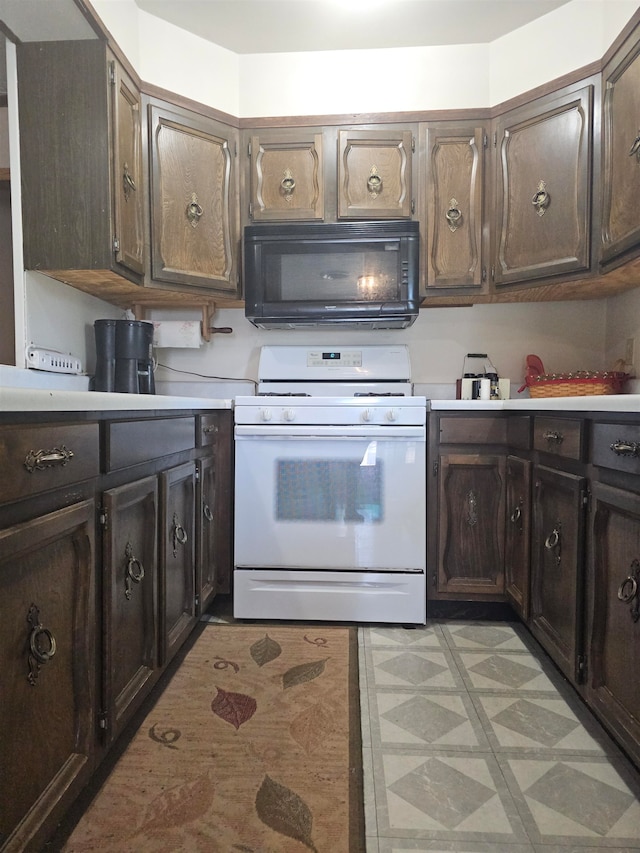 kitchen with white range oven and dark brown cabinets