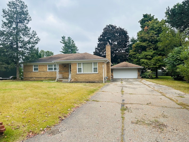 view of front facade with a garage, an outbuilding, and a front lawn