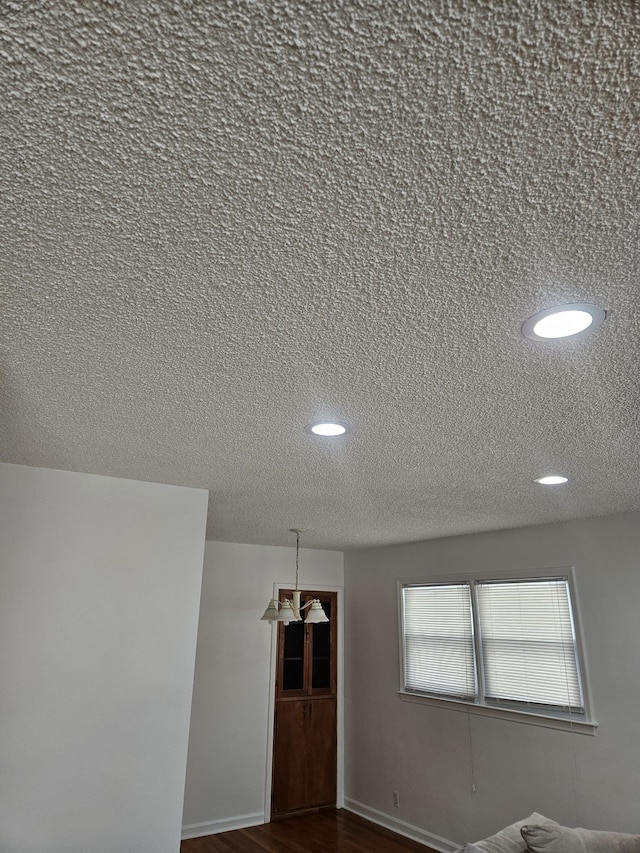 interior space with dark wood-type flooring and a textured ceiling